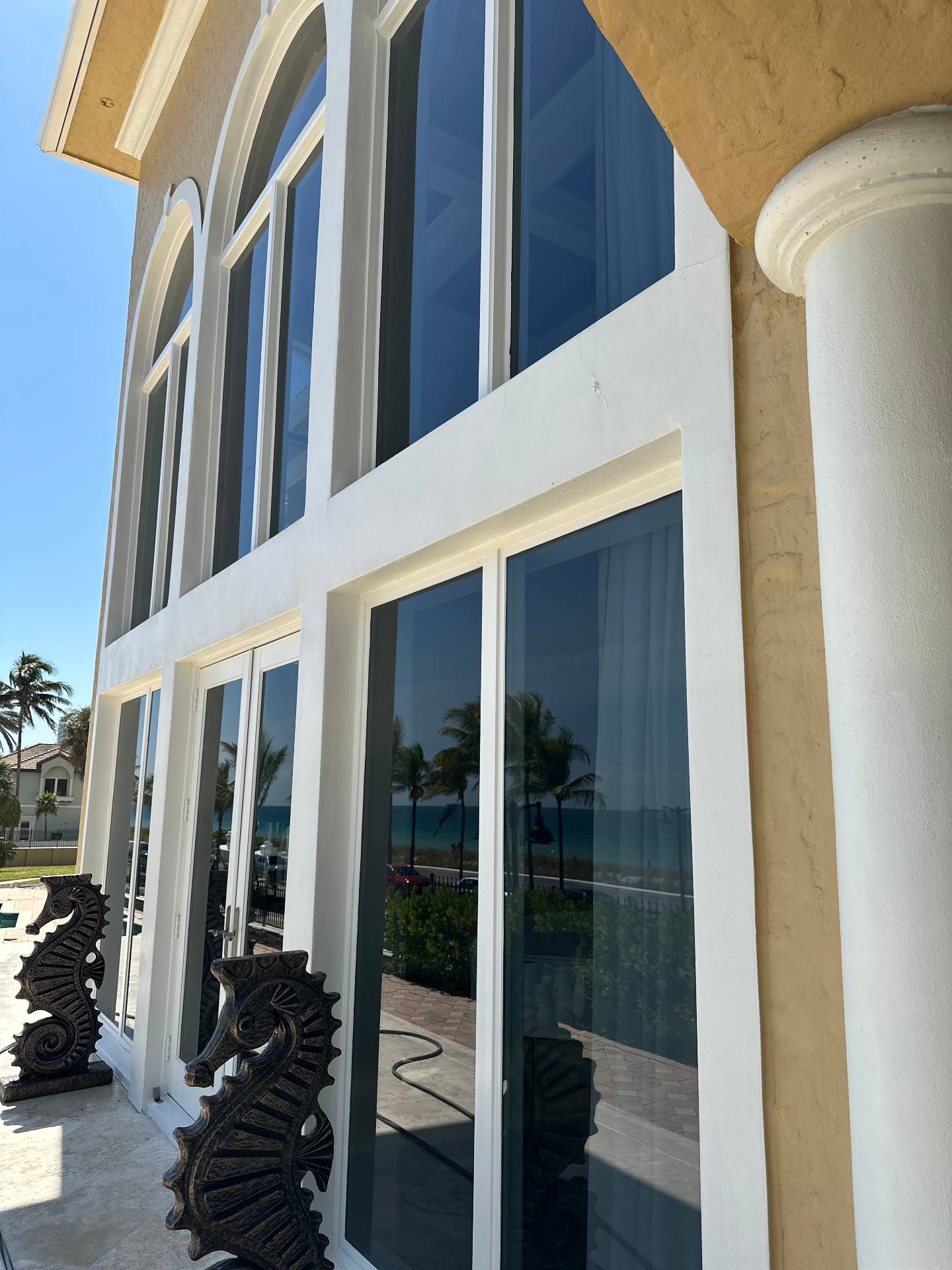 Recurring customer home with sparkling clean windows reflecting the ocean view